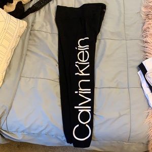 Black leggings with white writting down the leg